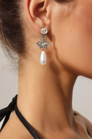 Roline inci ve taş detaylı fiyonk şeklinde küpeler